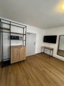 an empty room with a television and a table at rooms11 in Salzburg