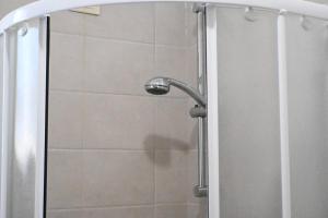 a shower with a shower head in a bathroom at Casa Vacanze Zefiro in Marzocca di Senigallia +10 photos