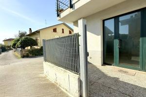 a building with a gate on the side of a street at Casa Vacanze Zefiro in Marzocca di Senigallia