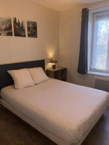 a bedroom with a large bed with a window at A&J Family - Neuvy sur Loire - Guédelon in Neuvy-sur-Loire