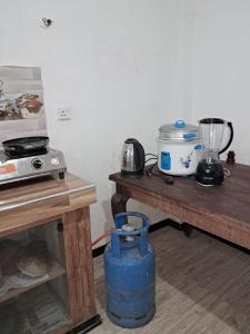 a kitchen with two tables and a blender and a table at Whits villa 24 in Matara