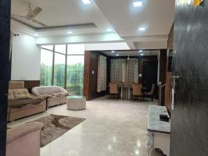 a living room with a couch and a table at Hangout Villa in Malavli