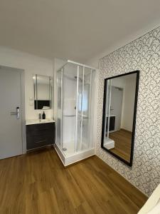 a bathroom with a shower and a sink and a mirror at rooms11 in Salzburg +91 photos