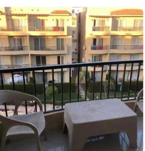 a balcony with a table and chairs and a building at The view resort nabq in Sharm El Sheikh