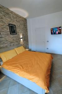 a bed in a room with a brick wall at Mira Beach Casa Vacanze in Praia a Mare