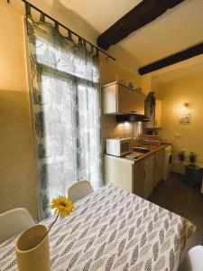 a kitchen with a table with a sunflower on it at Les 12 Sables in Le Lavandou