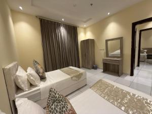 a hotel room with a bed and a mirror at Marina Jada hotel in Jeddah