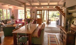 a living room with a wooden table and chairs at Riverfront Guesthouse ,Watermeadows farm in Sedgefield