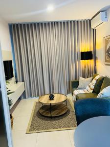 a living room with a couch and a coffee table at The Kgale Luxe in Gaborone