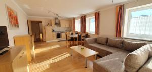 a living room with a couch and a table at Gästehaus Kirchenbauerhof in Günzburg