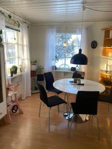 a living room with a table and chairs at Little adorable red in Kiruna
