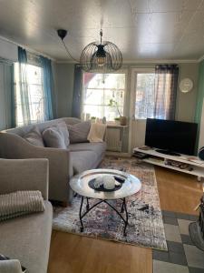 a living room with a couch and a coffee table at Little adorable red in Kiruna