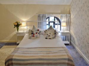 a bedroom with a large bed with two night stands at Rosecraddoc Manor - Hayloft in Saint Cleer