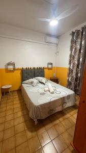 a bedroom with a large bed in a room with yellow walls at Appt La Rose du Désert in Terre-de-Haut +6 photos