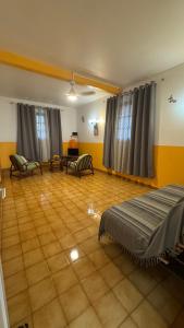 a large room with a bed and a living room at Appt La Rose du Désert in Terre-de-Haut
