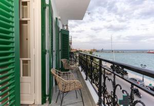 a balcony with chairs and a view of the water at Bosi Suites 2 in Zakynthos