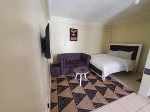 a small room with a bed and a chair at Nimmoh home in Rungiri