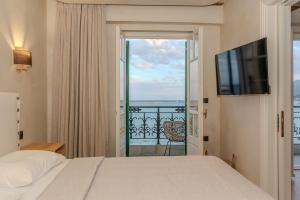 a bedroom with a bed and a view of the ocean at Bosi Suites 2 in Zakynthos