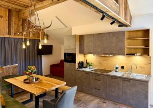 a kitchen and dining room with a wooden table at Das Lisal in Zell am Ziller +14 photos