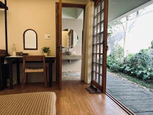 a room with a desk and a table with a mirror at Ansora Homestay Huế in Thôn An Hòa