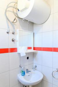a bathroom with a sink and a mirror at Studio Merlin 4 in Soko Banja +3 photos