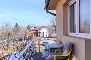 a balcony with a table and chairs and a window at Studio Merlin 4 in Soko Banja
