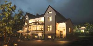 a large building with a lit up facade at night at Dom Retro Pivnica in Jastrzębie Zdrój