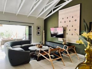 a living room with a couch and a table at Rhula Villa - Stylish Private Safari Villa in Hoedspruit