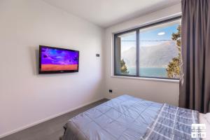 a bedroom with a bed and a large window at SYMPHONY HOUSE by Design Studio in Bellano
