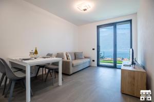 a living room with a table and a couch at SYMPHONY HOUSE by Design Studio in Bellano