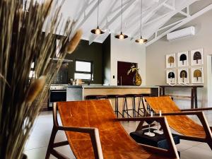 two wooden tables and chairs in a kitchen at Rhula Villa - Stylish Private Safari Villa in Hoedspruit