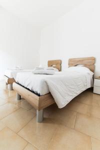 two beds sitting on a wooden platform in a bedroom at Losa Rooms in Abbasanta