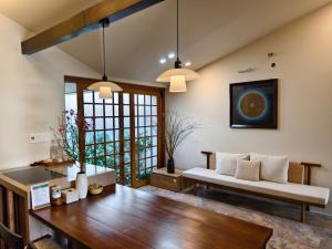 a living room with a bench and a table at Ansora Homestay Huế in Thôn An Hòa +94 photos