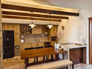 a kitchen with wooden cabinets and a wooden table at Ansora Homestay Huế in Thôn An Hòa