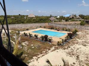 an overhead view of a swimming pool in a resort at Karafuu Nyama Choma Lodge in Bwejuu