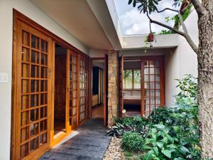 an open door of a house with a tree at Ansora Homestay Huế in Thôn An Hòa