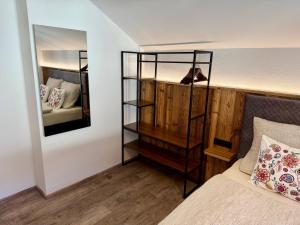 a bedroom with a bed and a mirror at Das Lisal in Zell am Ziller