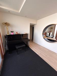 a living room with a piano and a mirror at Villa Bartolini in Bruges