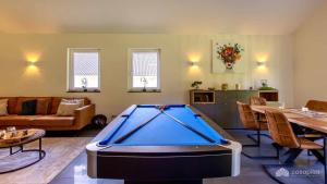 a living room with a pool table in it at Mom's Home in Burg-Reuland