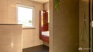 a bathroom with a shower and a sink and a window at Mom's Home in Burg-Reuland +20 photos