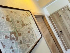 a map on a wall next to a door at Ju-Jolie in Bruges