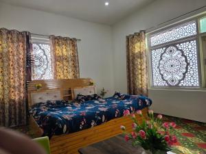 a bedroom with a bed and a large window at Payer Resort in Pharkian