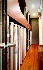 a row of stainless steel pipes in a room with wood floors at Start House 5 mins walk Airport in Ho Chi Minh City