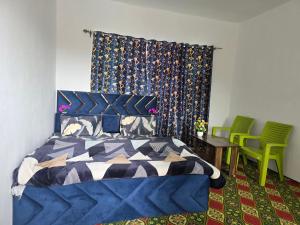 a bedroom with a bed and a table and chairs at Payer Resort in Pharkian +6 photos