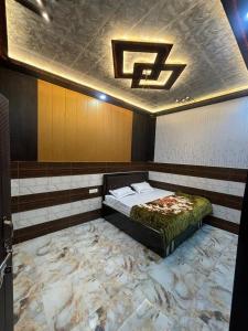 a bed in a room with a marble floor at Seeta Palace in Ayodhya