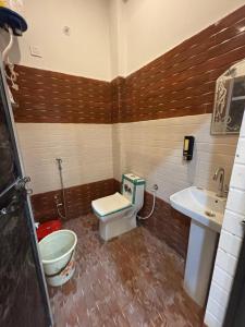 a bathroom with a toilet and a sink at Seeta Palace in Ayodhya