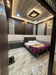 a bedroom with a bed with a marble floor at Seeta Palace in Ayodhya +5 photos