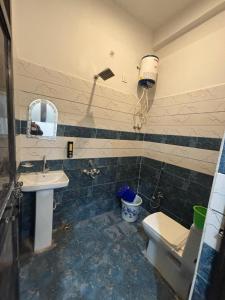 a bathroom with a sink and a toilet at Seeta Palace in Ayodhya