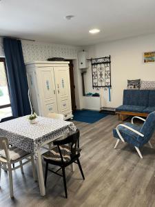 a living room with a table and chairs and a couch at Venkovský odpočinek in Hroznětín