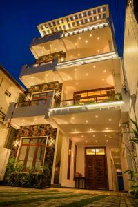 a facade of a house at night at Trinco Beachfront Villas AJS in Trincomalee